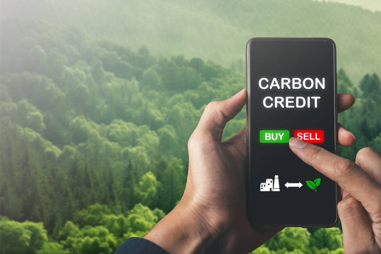 Man trading carbon credit.net zero target, buy and sell carbon credit concept.CO2 emission reduction to stop global warming problem and reduce pollution into atmosphere from big industrial.