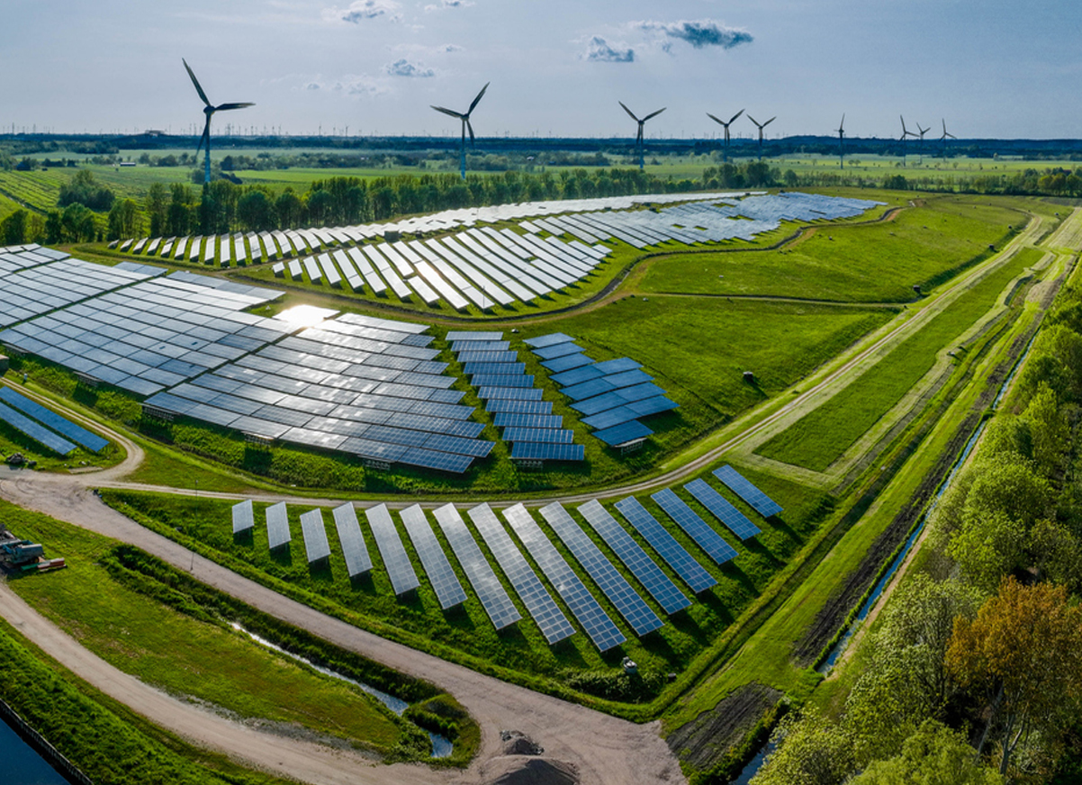 Aerial view of coal power plant with steam rising from cooling towers.